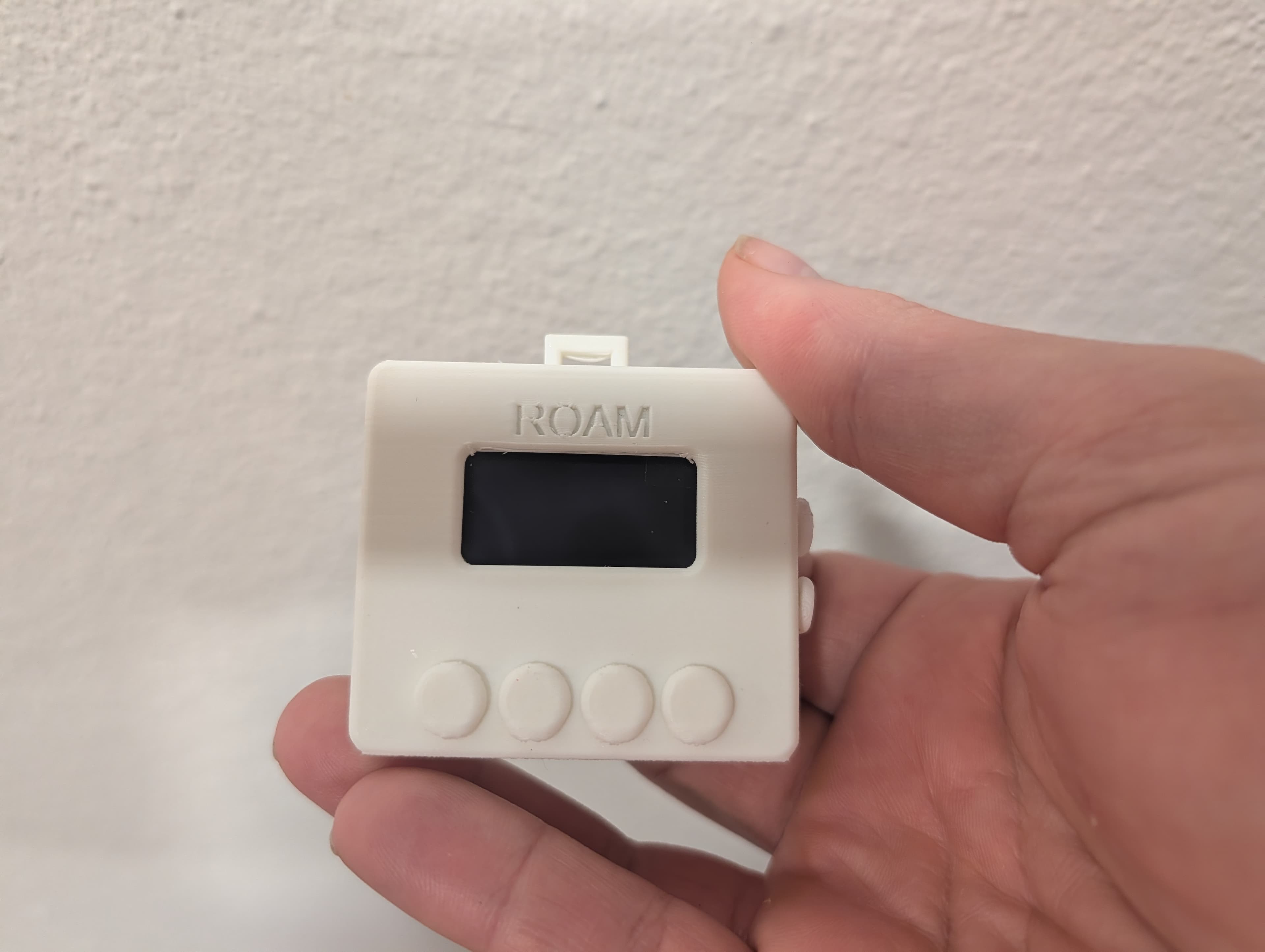 Roam — wrist-mounted BLE controller held in fingers